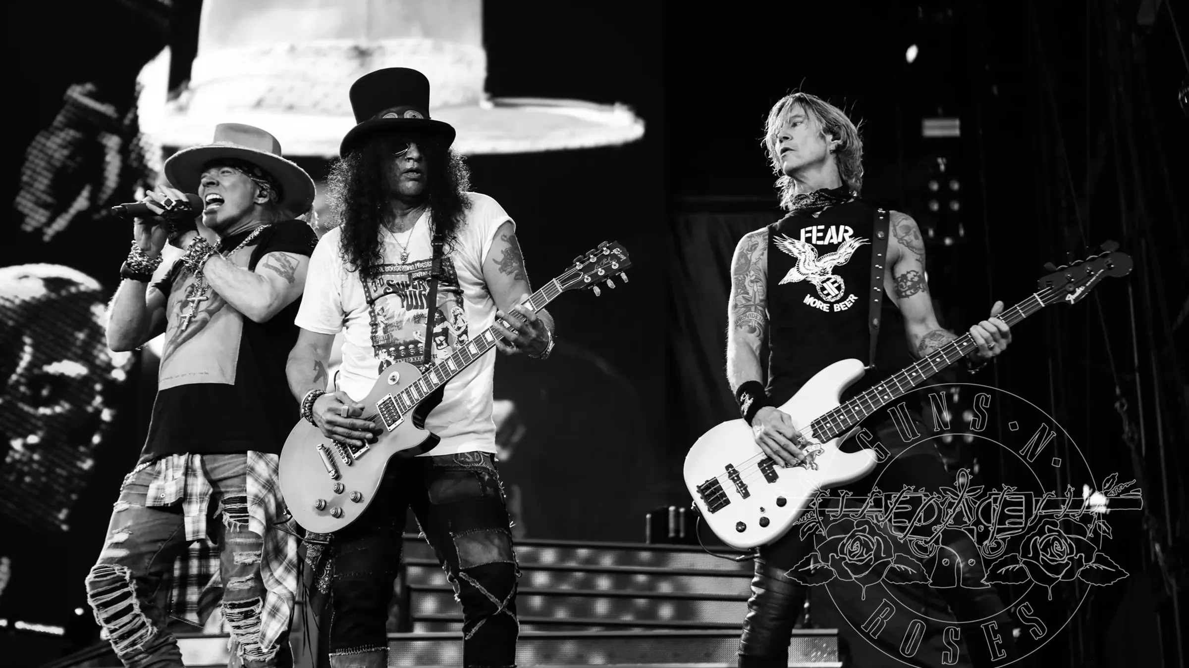 a group of men playing guitars on a stage