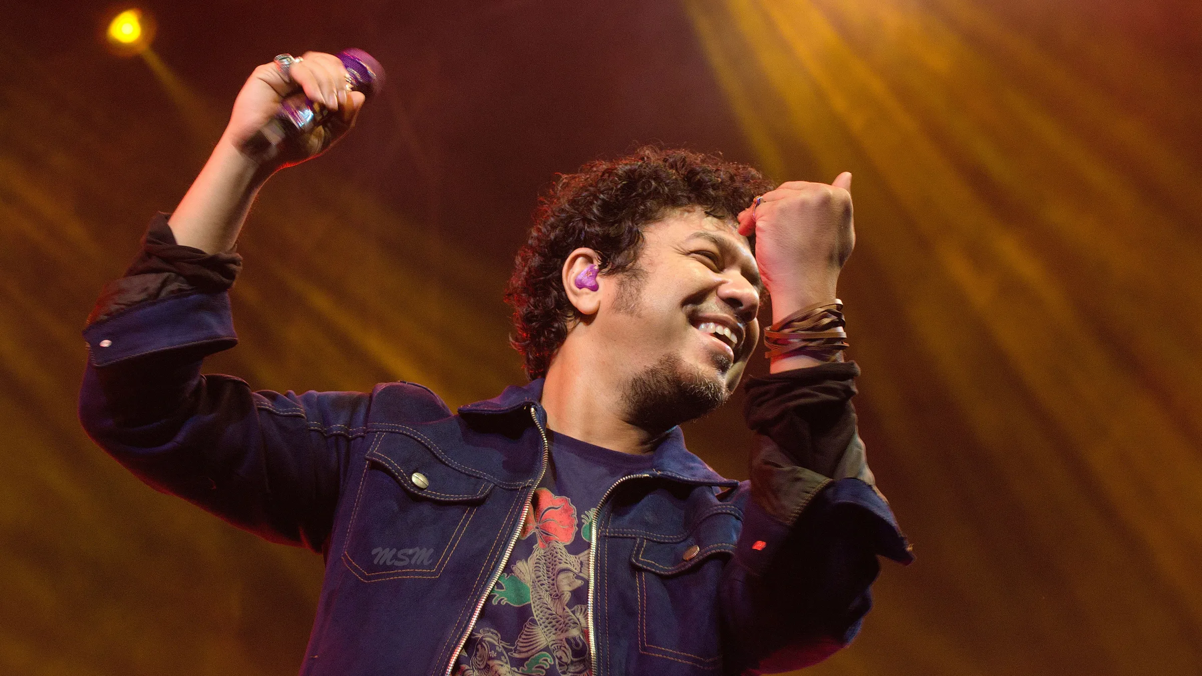 a man holding a microphone and smiling