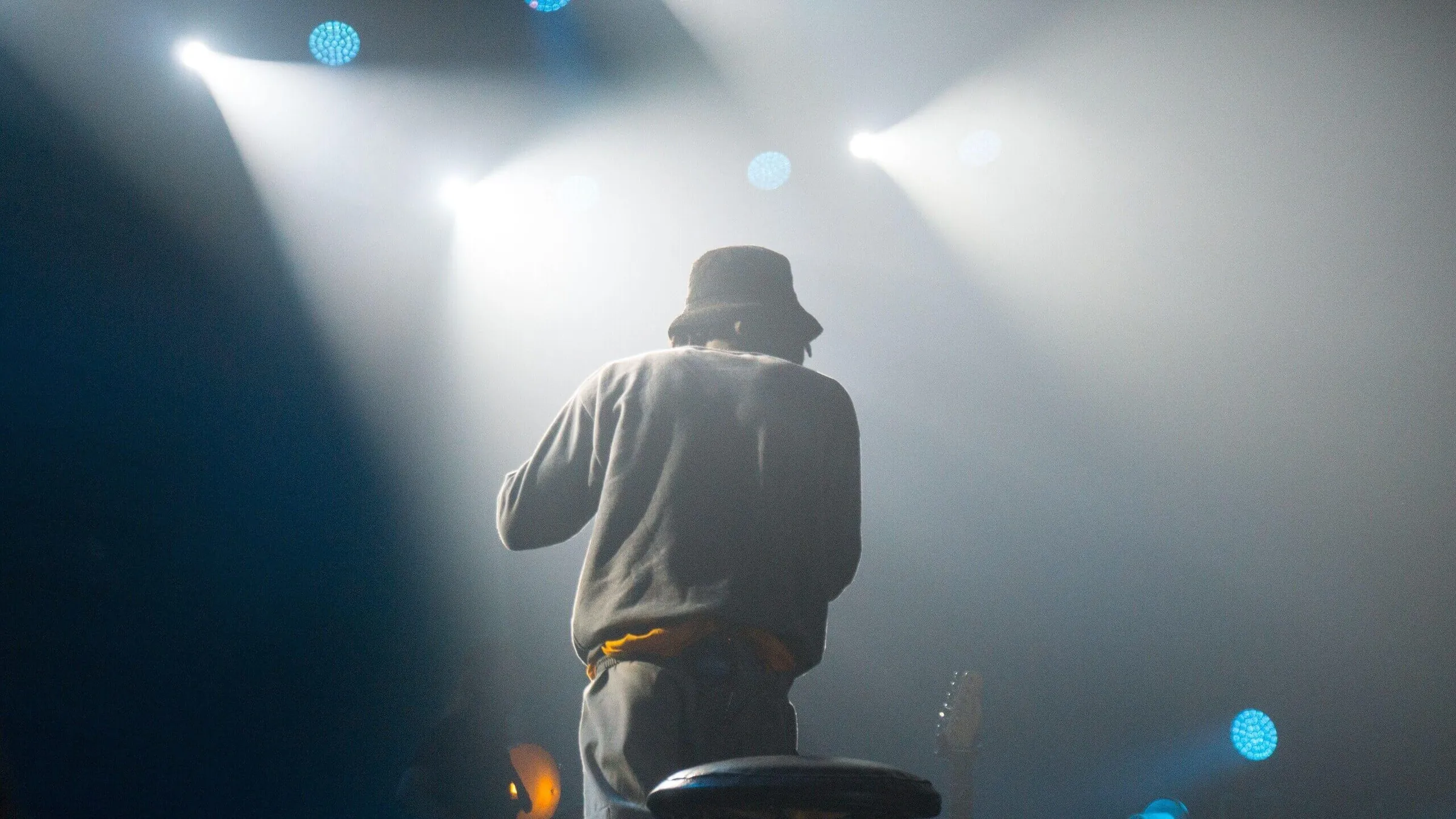 a man standing on a stage with lights