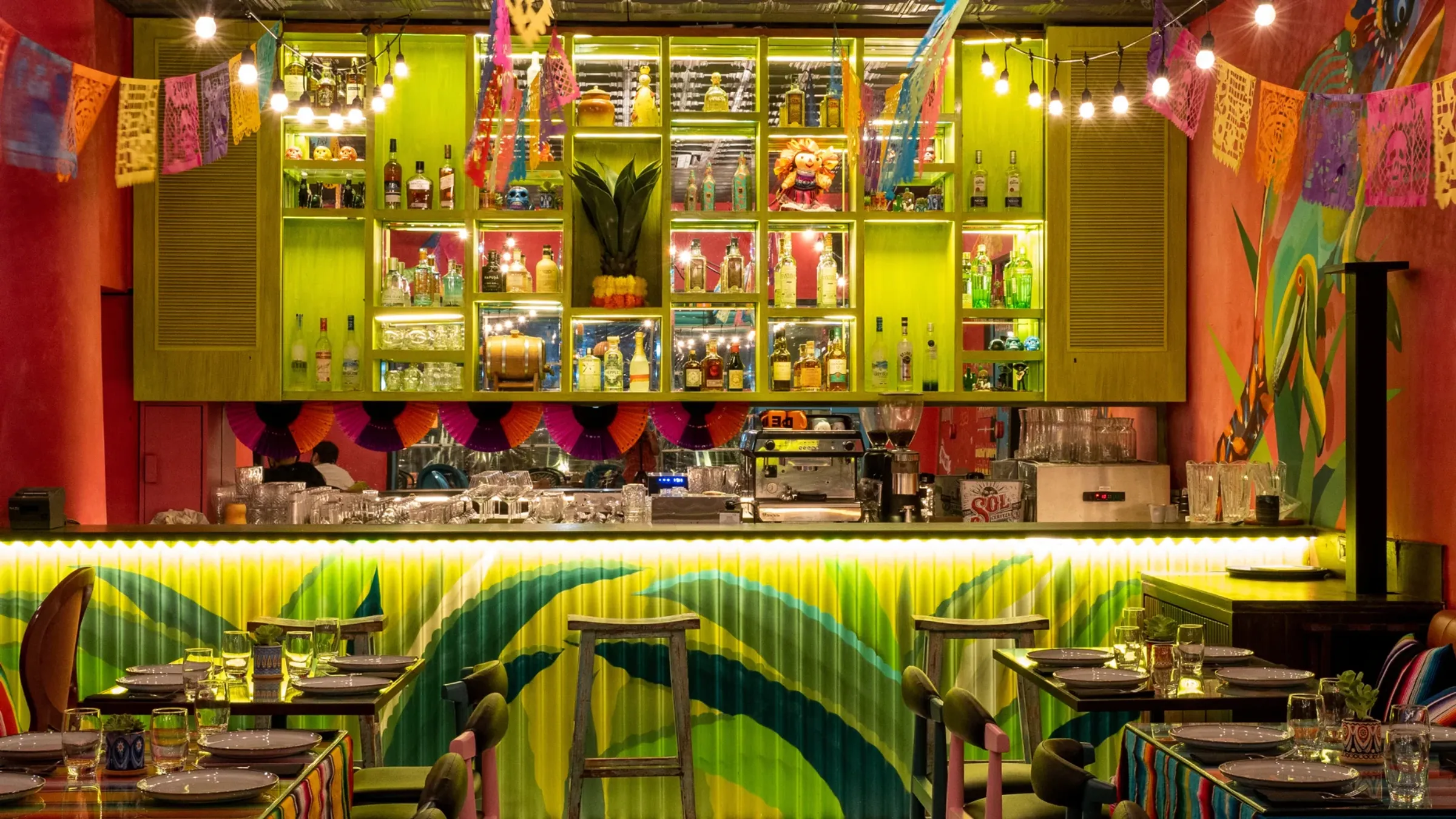 a bar with colorful shelves and bottles