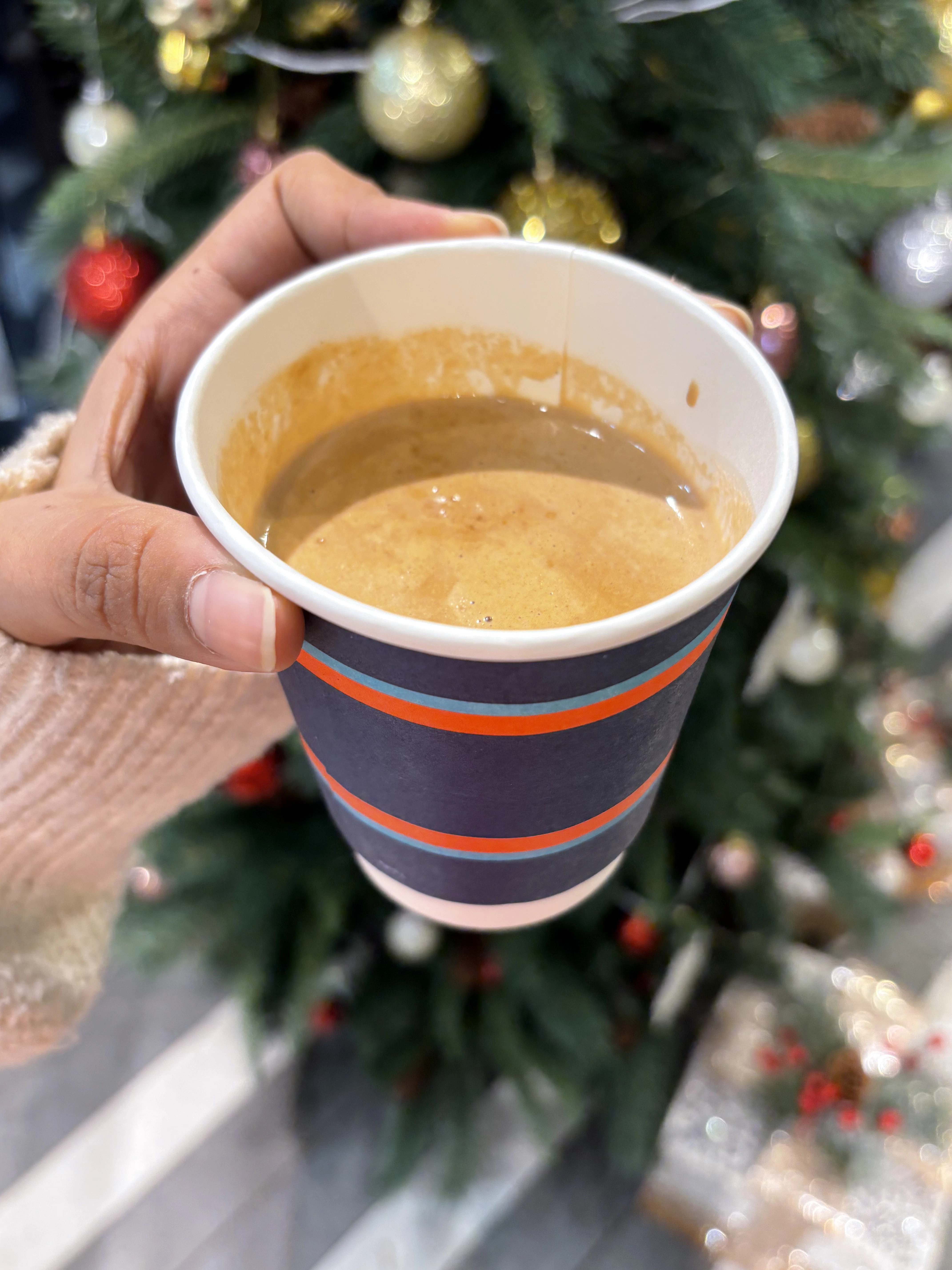 a hand holding a cup of coffee