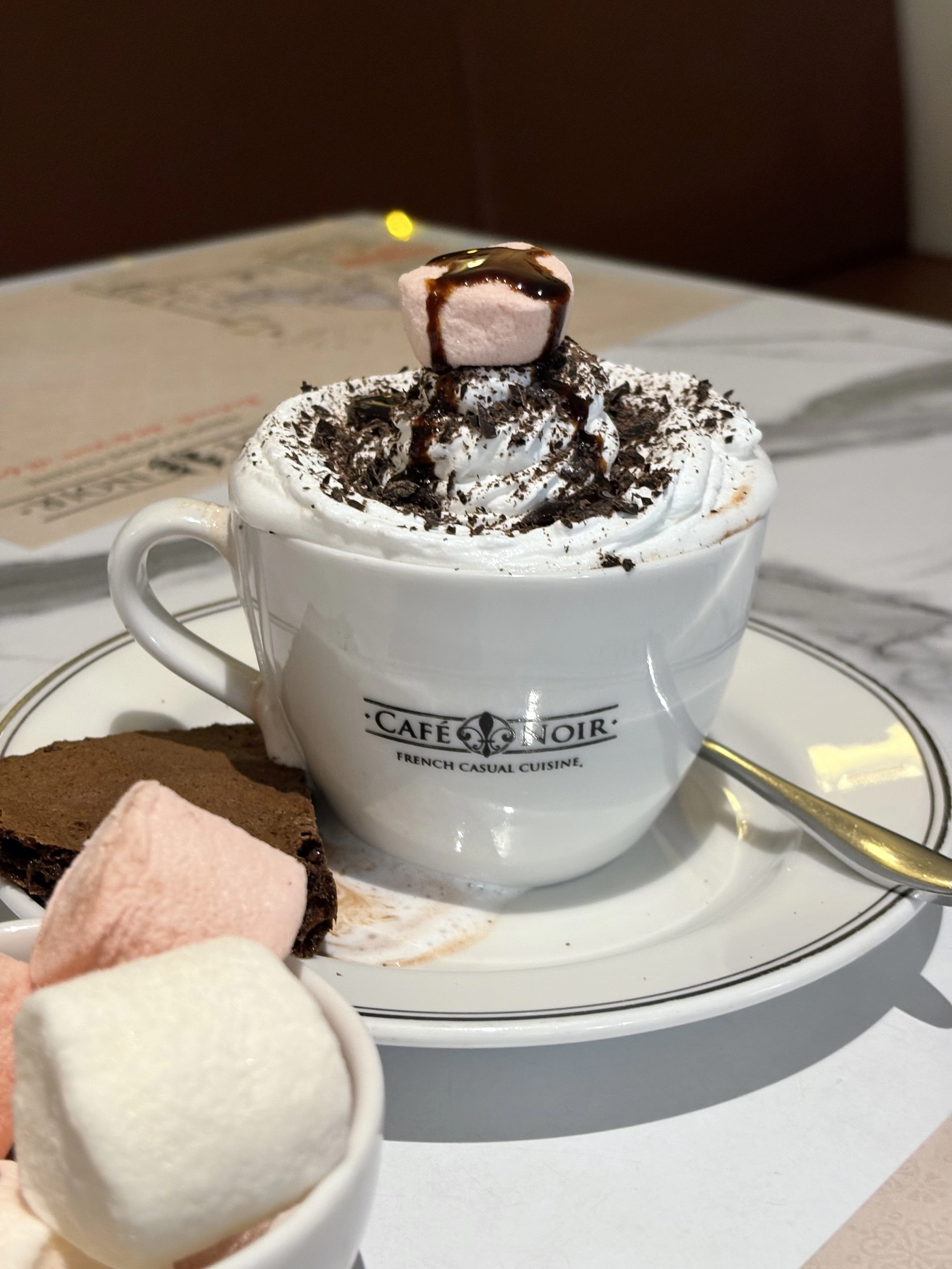 a cup of hot chocolate with marshmallows on top