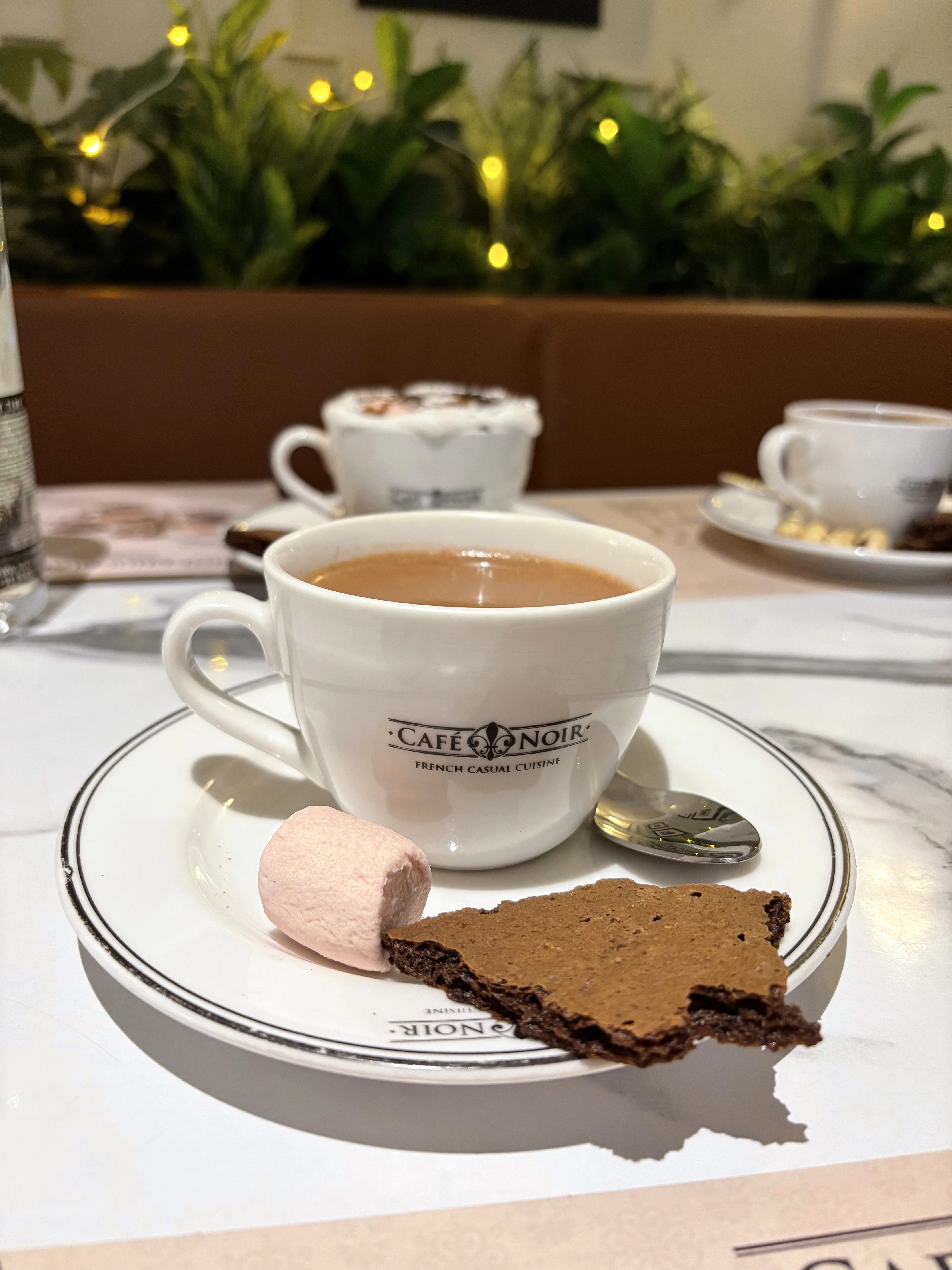 a cup of coffee and a brownie on a plate