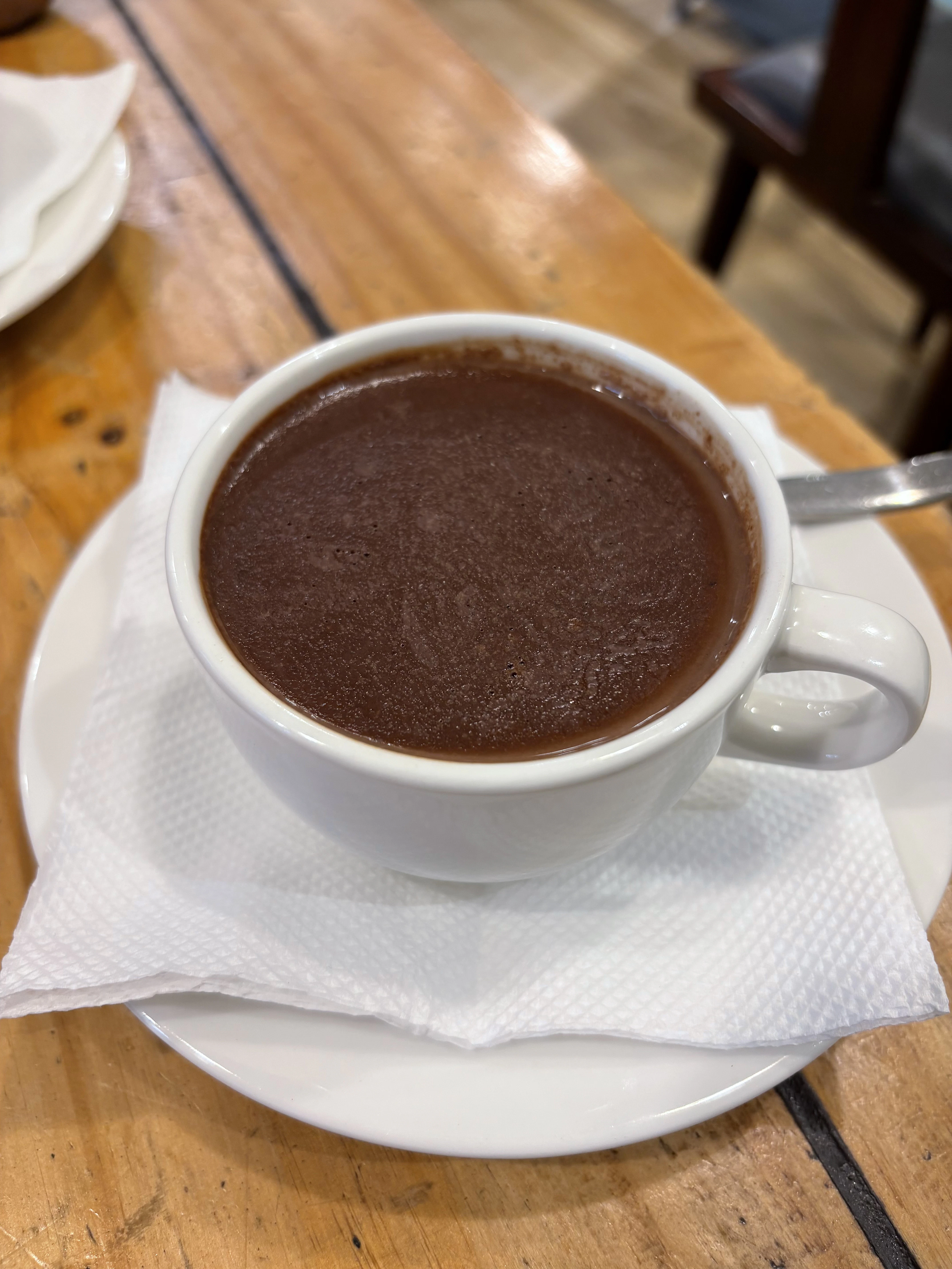 a cup of hot chocolate on a plate