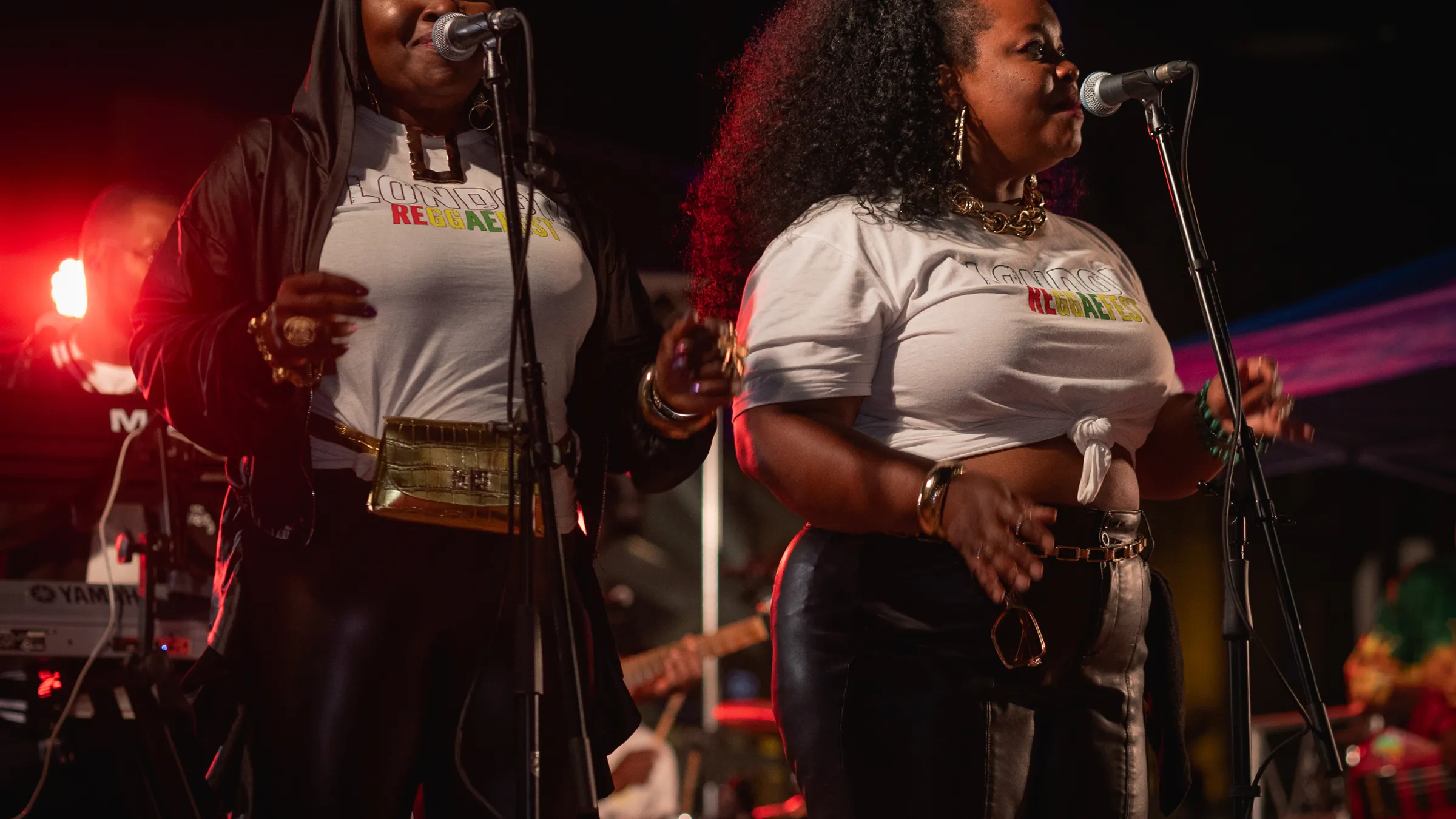 two women singing on a stage
