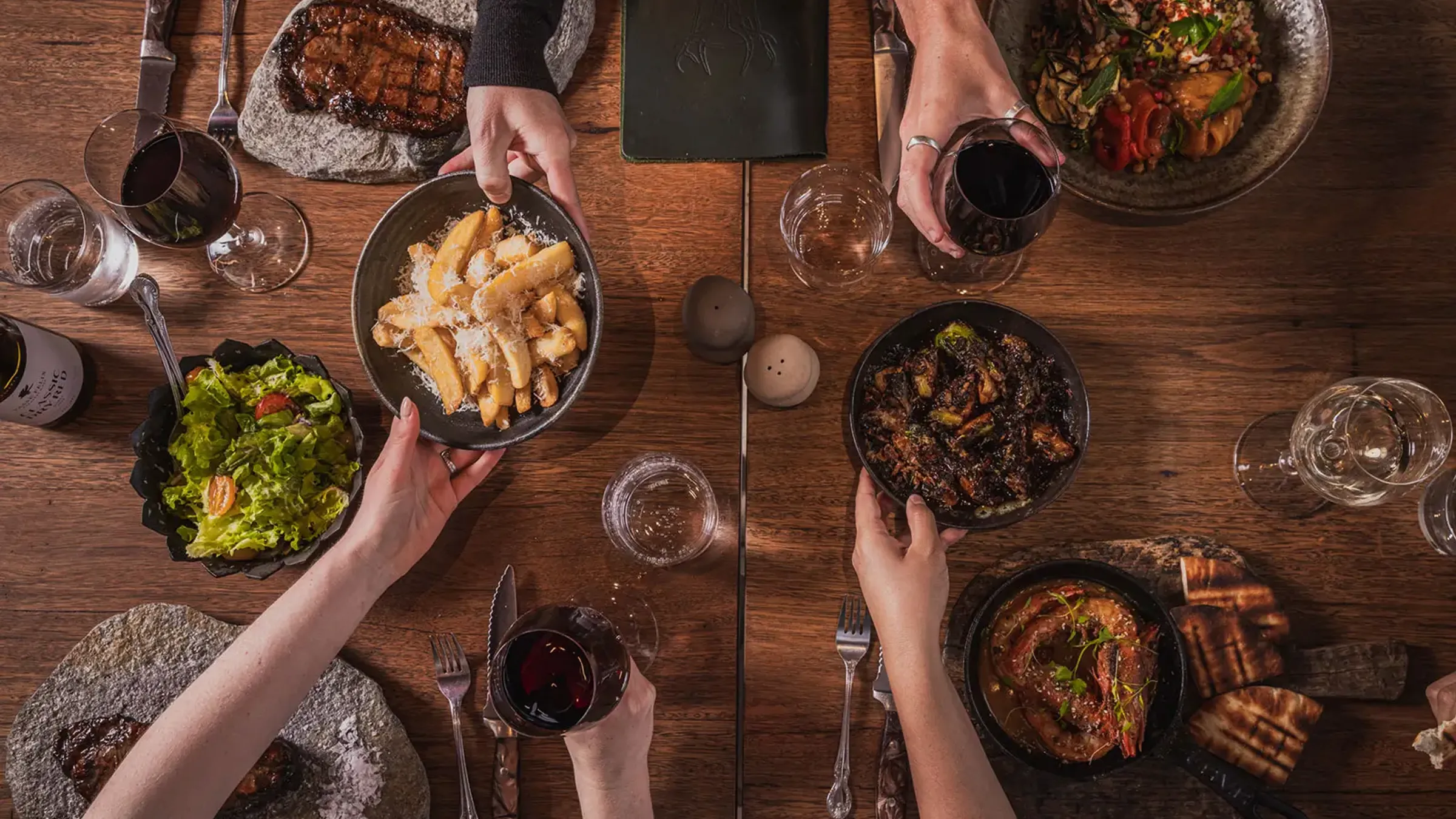 a group of people eating food at a table
