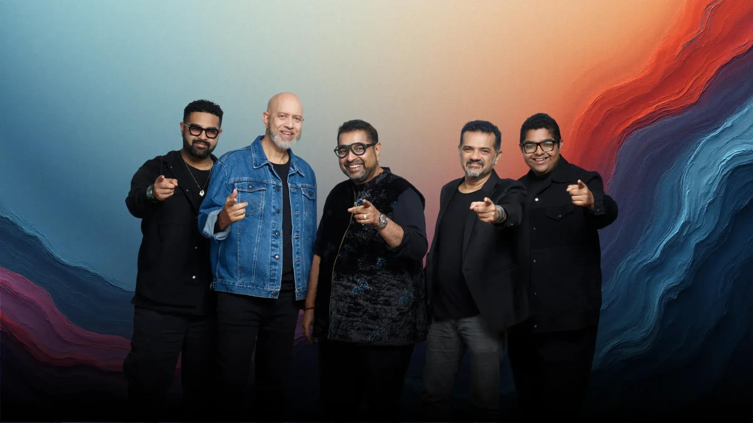 a group of men pointing at the camera