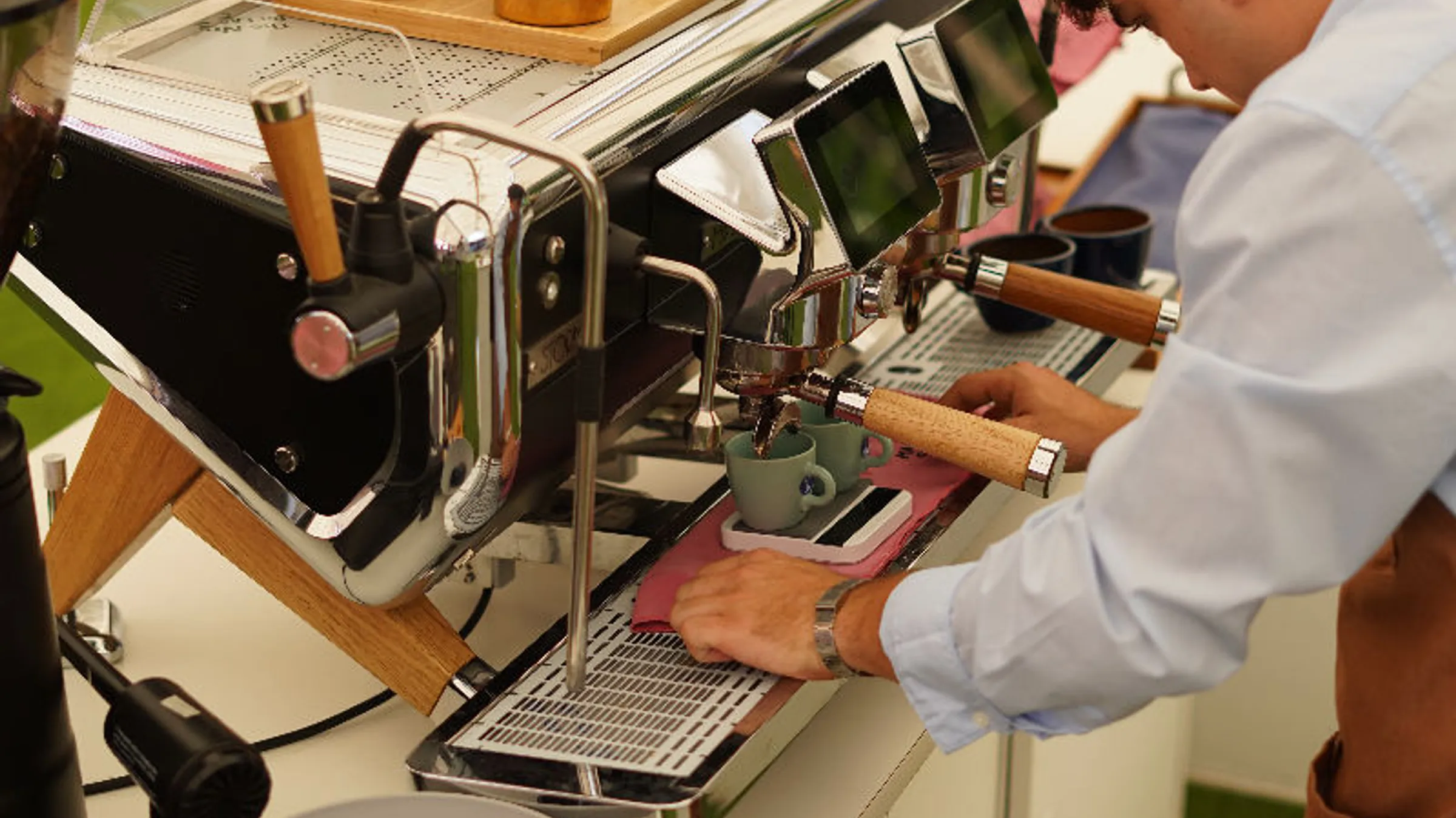 a man making coffee at a coffee machine