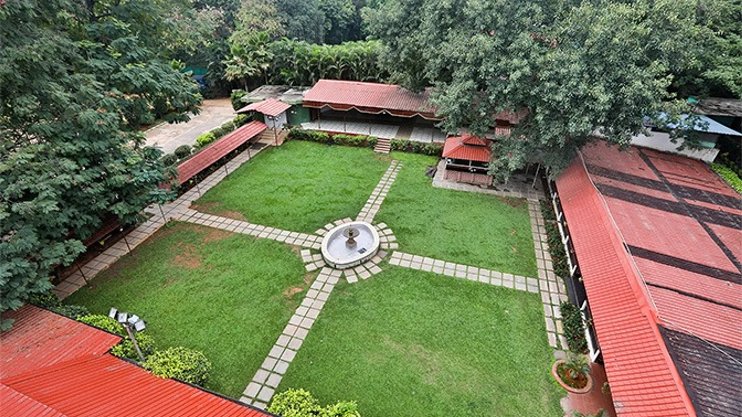 a courtyard with a fountain and trees
