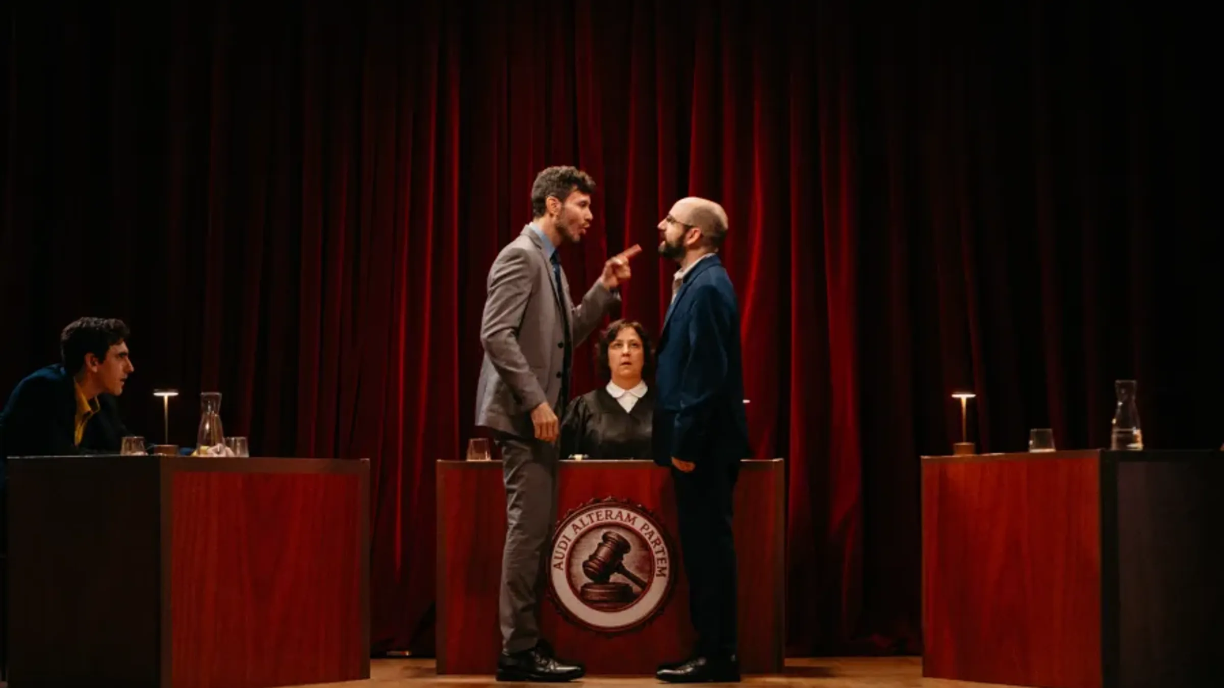 a man in a suit standing next to a woman in a podium