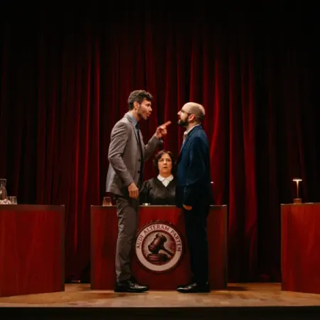 a man in a suit standing next to a woman in a podium