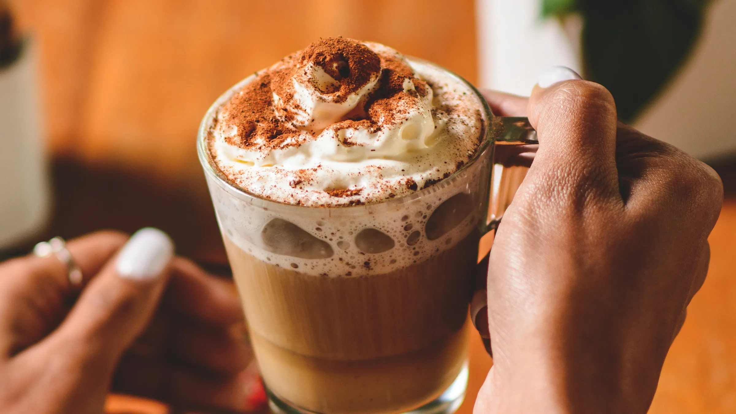 a person holding a glass of coffee