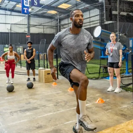 a man jumping on a platform in a gym